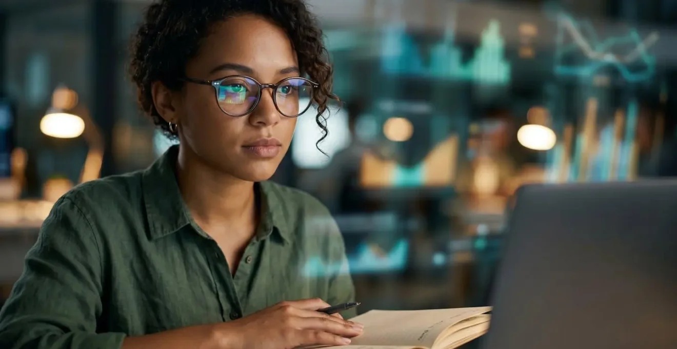 A focused journalist working alongside AI tools, with data visualizations reflected in their glasses, symbolizing human-AI collaboration.