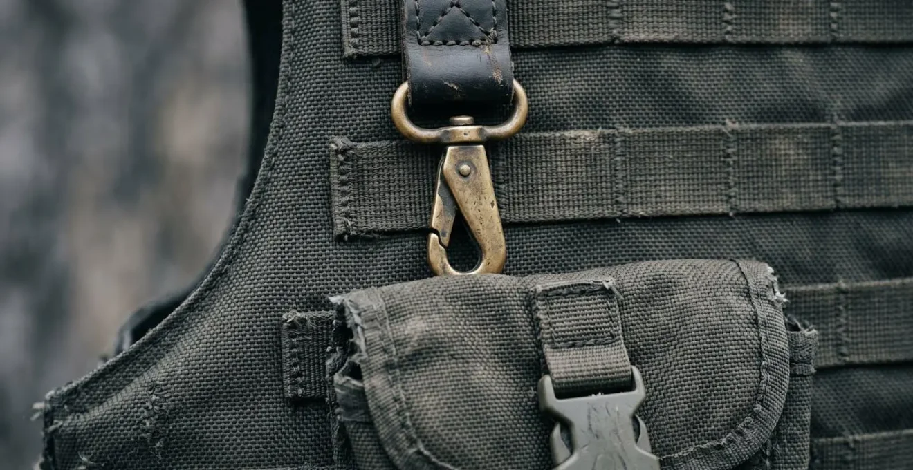 Close-up detail of journalist's protective equipment showing bulletproof vest textures and safety gear materials