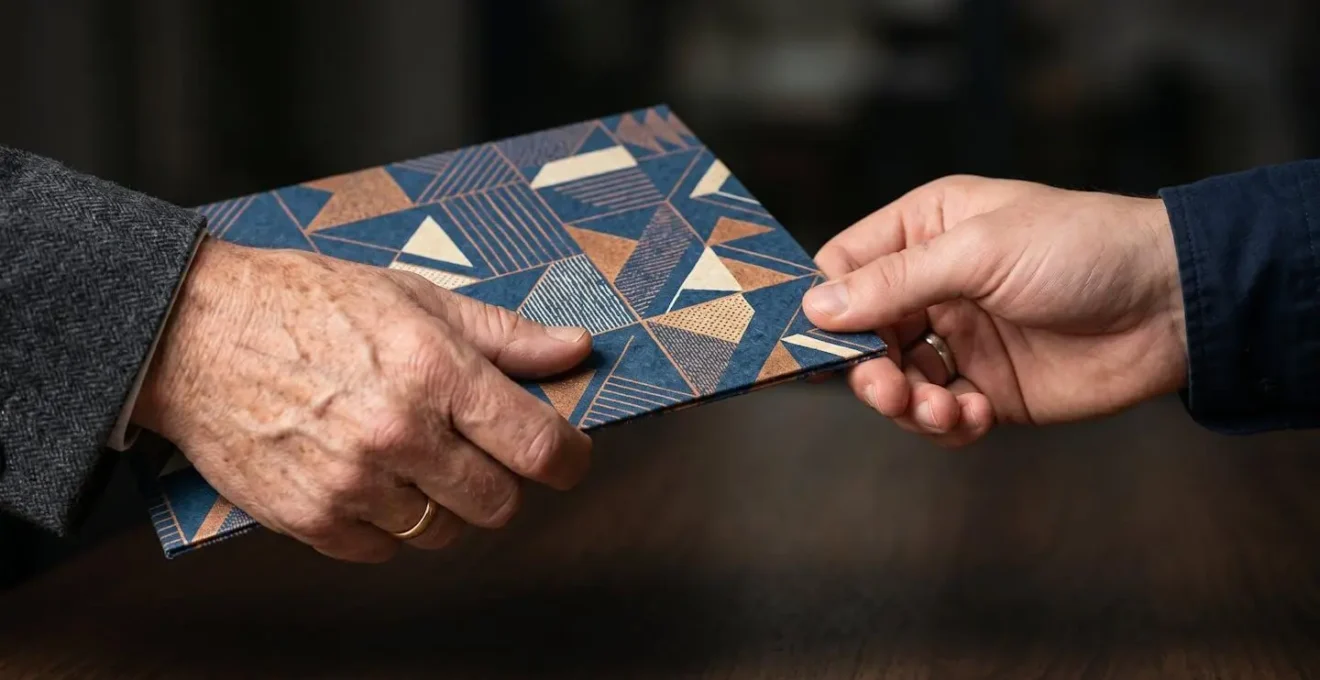 Close-up of hands exchanging professional documents